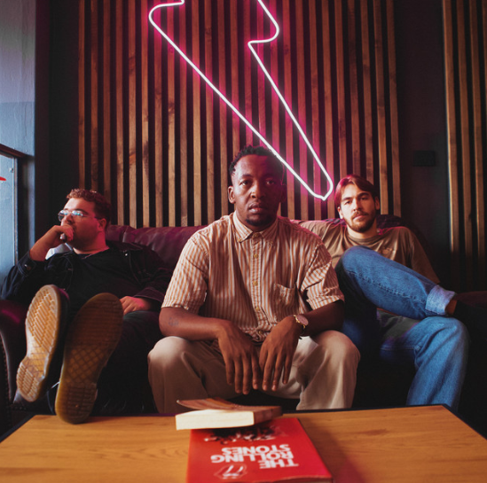 Album art of three men sitting on a couch