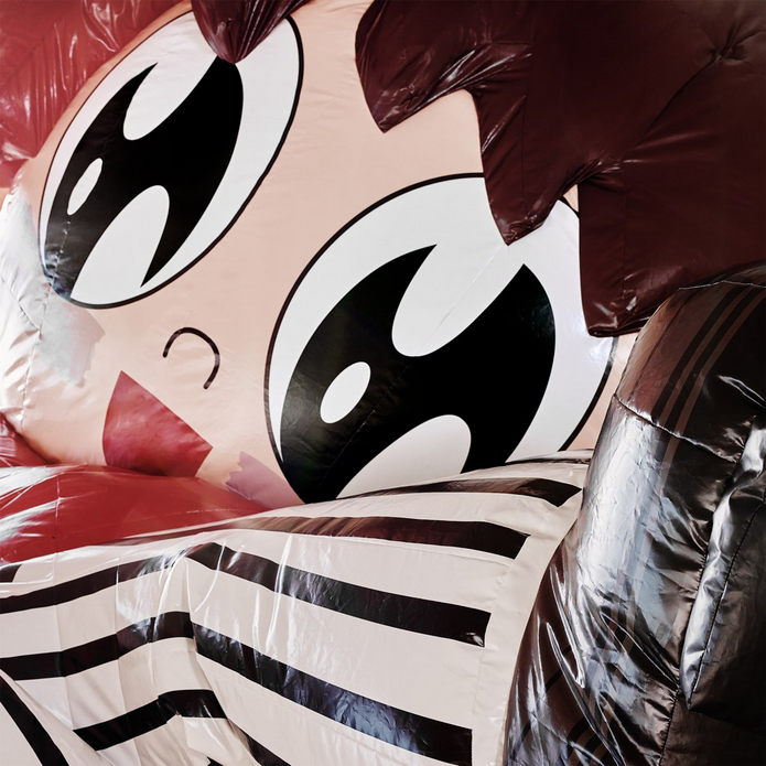 Large balloon with cartoon face on it